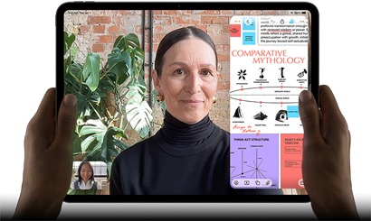 iPad Pro, front exterior, landscape orientation, space black color, rounded corners, black display bezel, hands holding left and right sides, display showing a FaceTime conversation being live translated, and an educational app showing a presentation of "Comparative Mythology" with text, diagrams, and handwritten notes